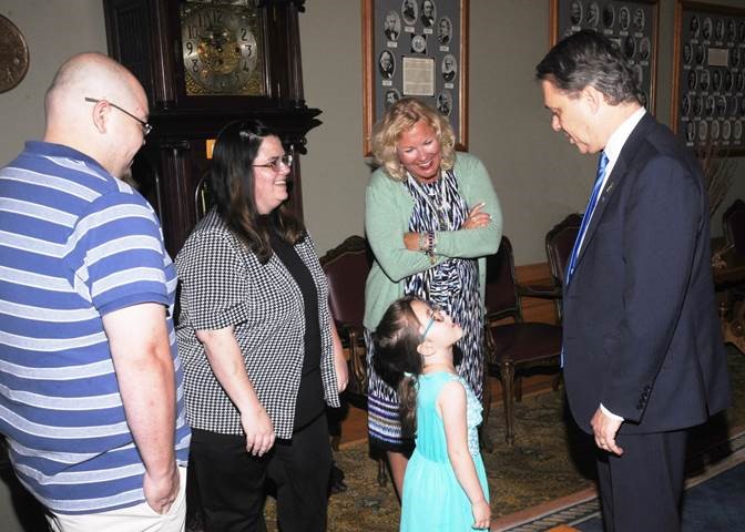 Family Reunification Month 2018 image of Governor Colyer with Secretary Gina Meier-Hummel talking to reunification family.
